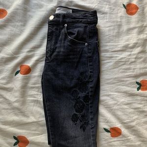 faded black floral accent garage jeans